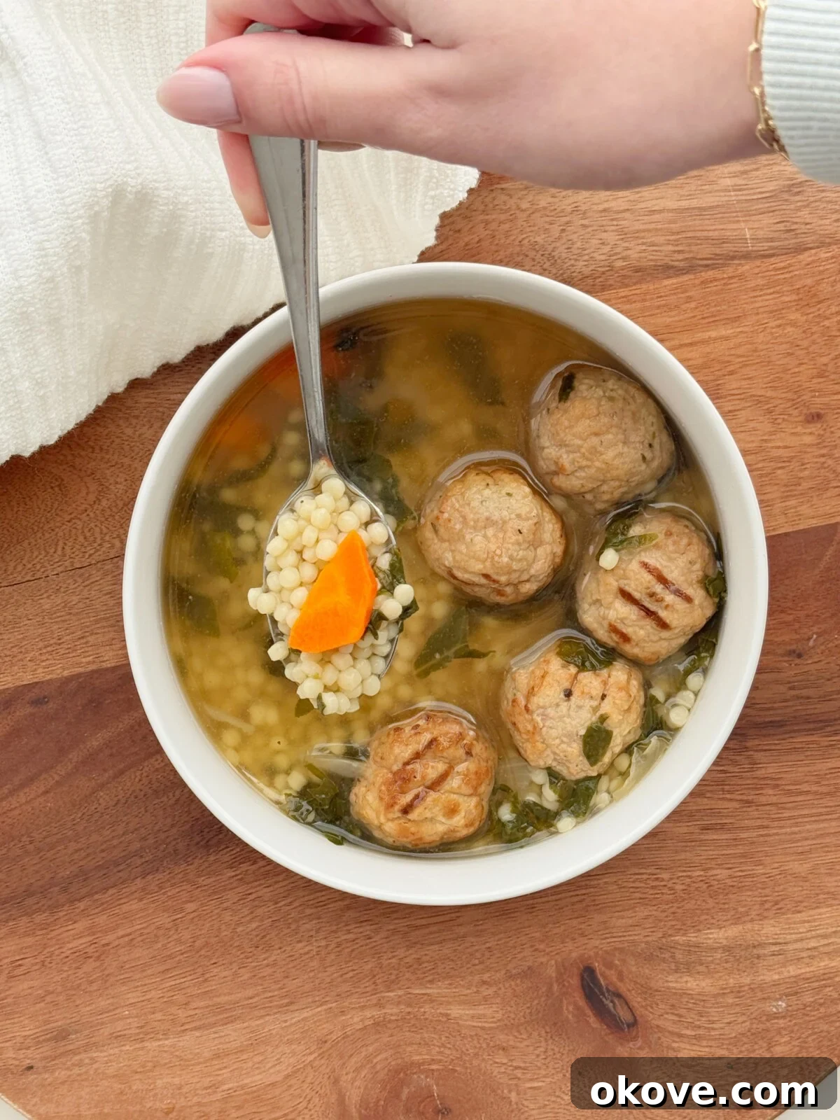 Soulful Italian Celebration Soup 2 Hearty Italian wedding soup in a rustic bowl, perfect for a family meal.