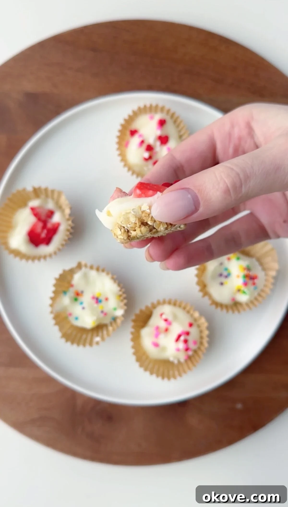 Granola Yogurt Energy Bites 3 A hand holding half of a yogurt granola bite