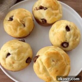 Five cottage cheese muffins on a white plate.