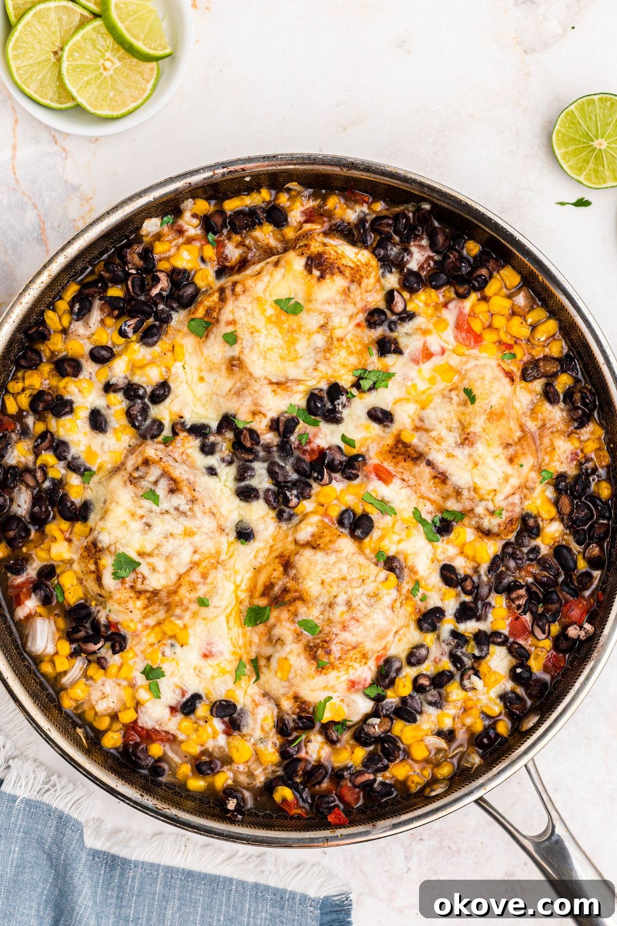 Pieces of chicken covered with melted cheese and mixed with corn, black beans, and other ingredients.