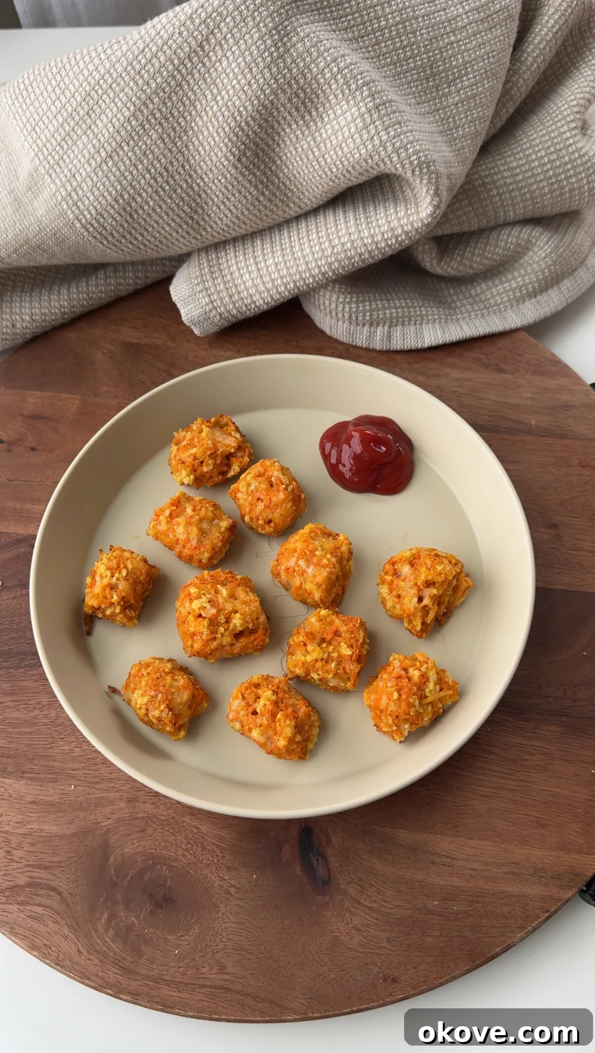 Golden Carrot Cheese Bites 2 Easy cheesy carrot tots on a plate with a side of ketchup