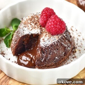Chocolate mini cake with gooey center coming out onto a white plate.