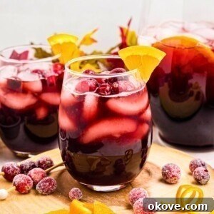 Sangria in a clear stemless glass with orange slice as a garnish.