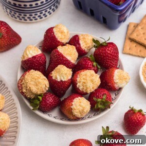 Cheesecake stuffed strawberries on a marble table.