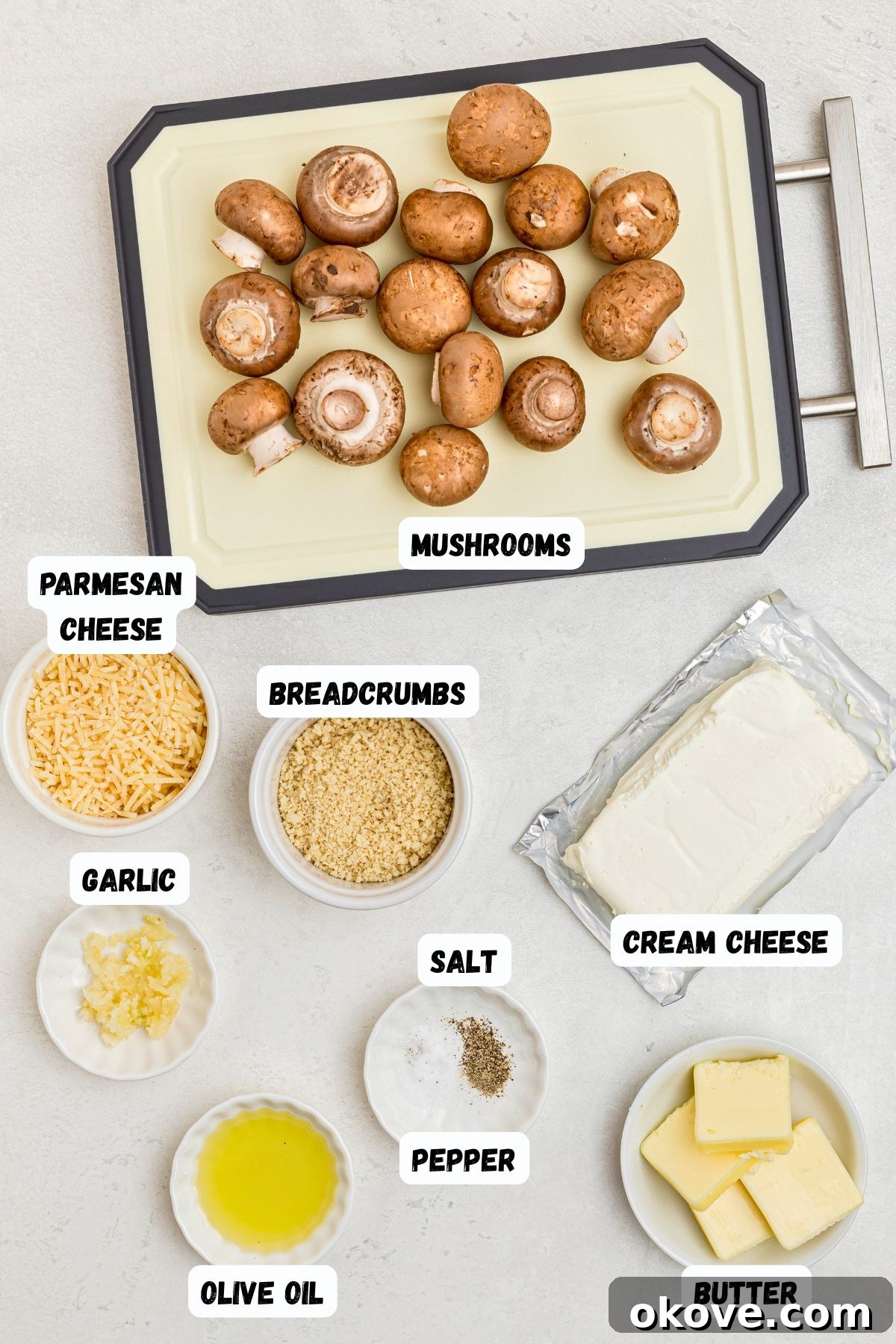 Ingredients measured out in small dishes, and labeled, on a white marble table. 