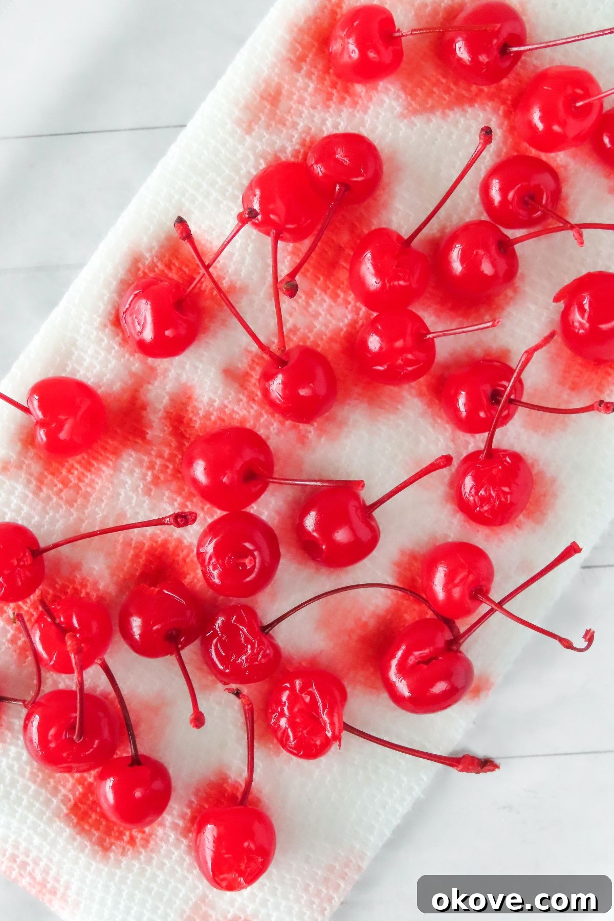 Bright red cherries, rinsed and laying out to dry on paper towels. 