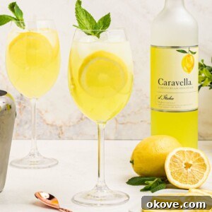 Fourth of July Recipes for a Memorable BBQ & Fireworks Night 15 Glass of yellow limoncello spritz, topped with a sprig of mint and a lemon slice garnish.