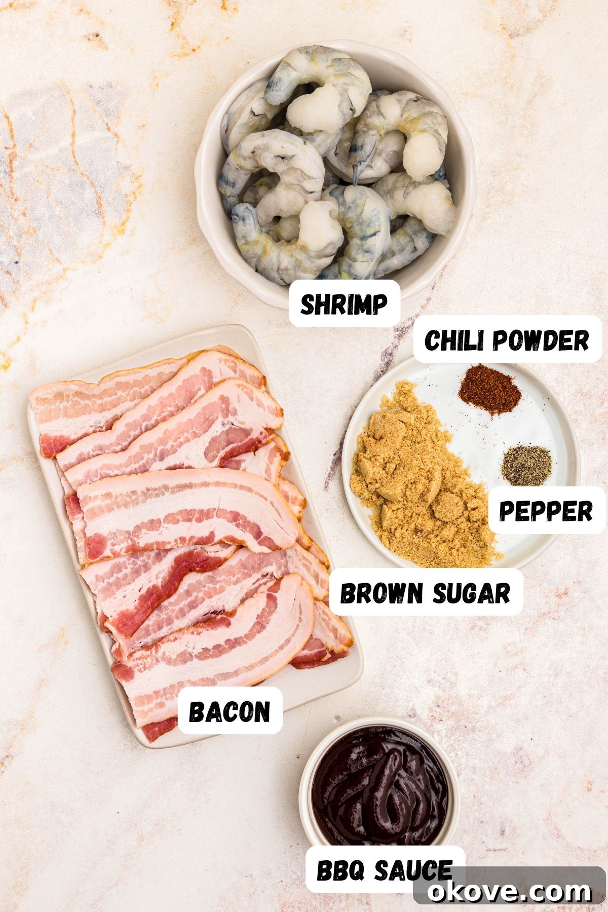 Crispy Bacon-Wrapped Shrimp Skewers with Garlic Butter Dip 3 Ingredients measured and labeled, needed to make bacon wrapped shrimp, on a marble table.
