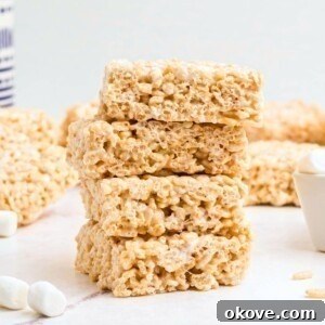 Rice Krispie treats stacked on a marble table.