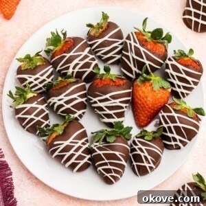 Chocolate covered strawberries on a white plate.