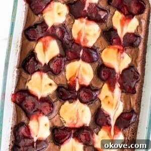 Strawberry cheesecake brownies baked in a glass dish.