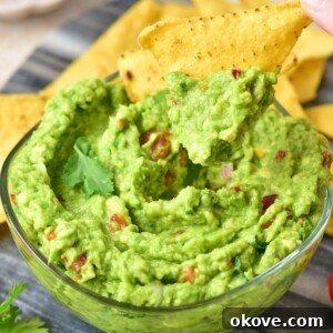 Guacamole with chopped tomatoes and onions.