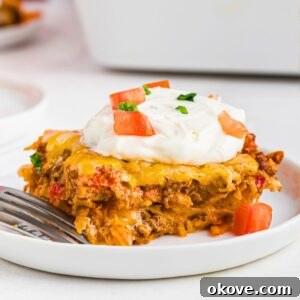 Dorito casserole slice on a white plate.