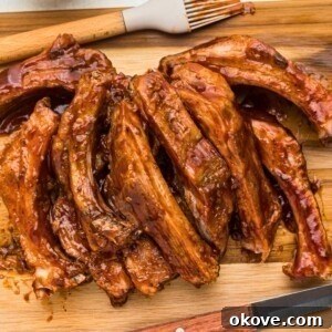 Baby back ribs on a wooden cutting board.