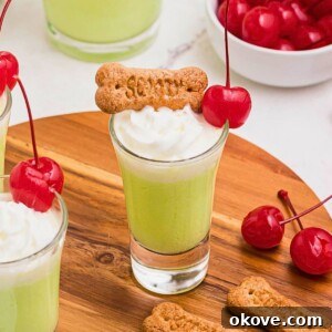 Scooby Snack Shot with green liquid and whipped cream.