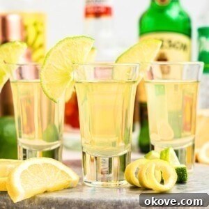 Green tea shot served with lime garnish.