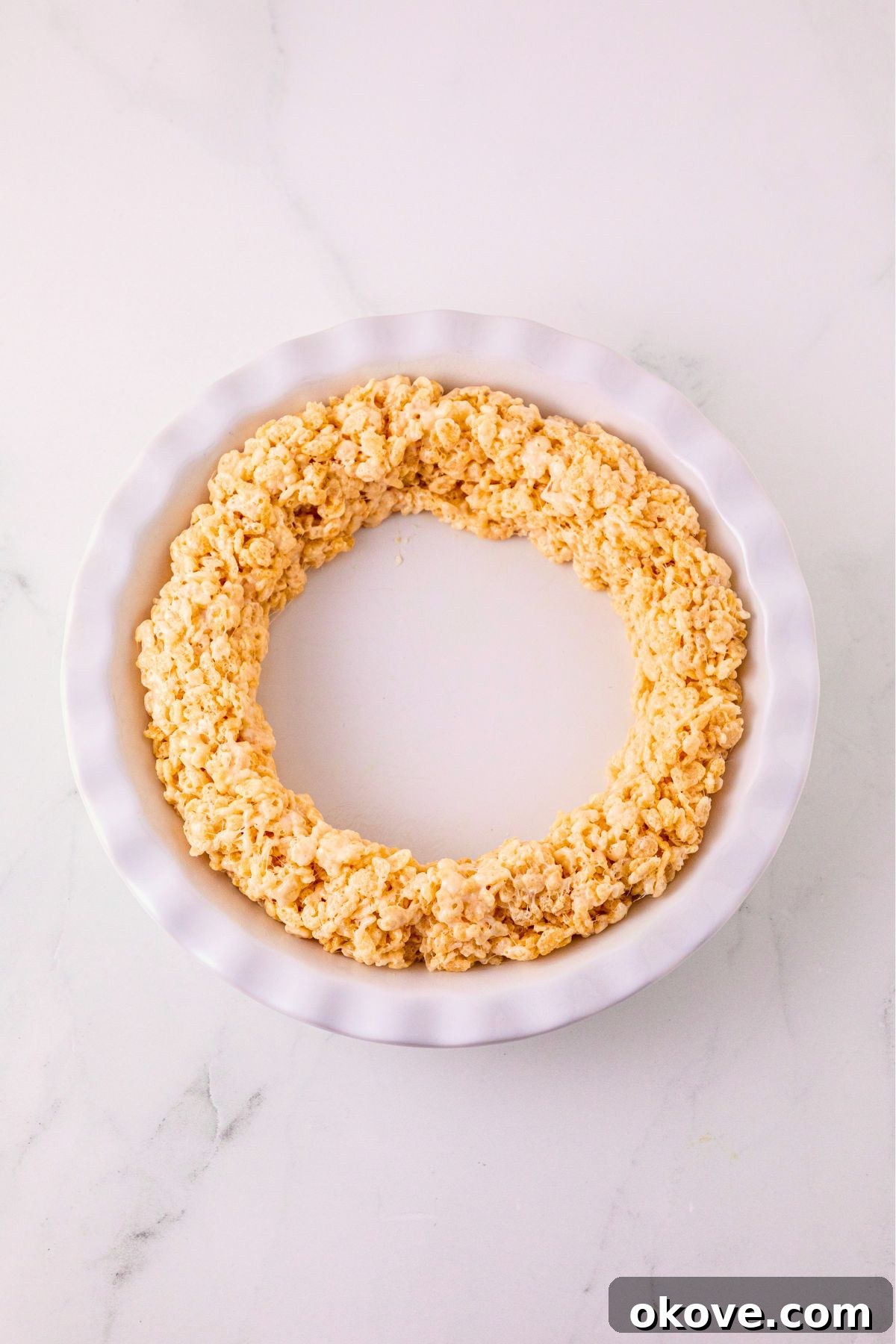 Ring of rice krispies shaped into a ring, pressed into a white pie plate.