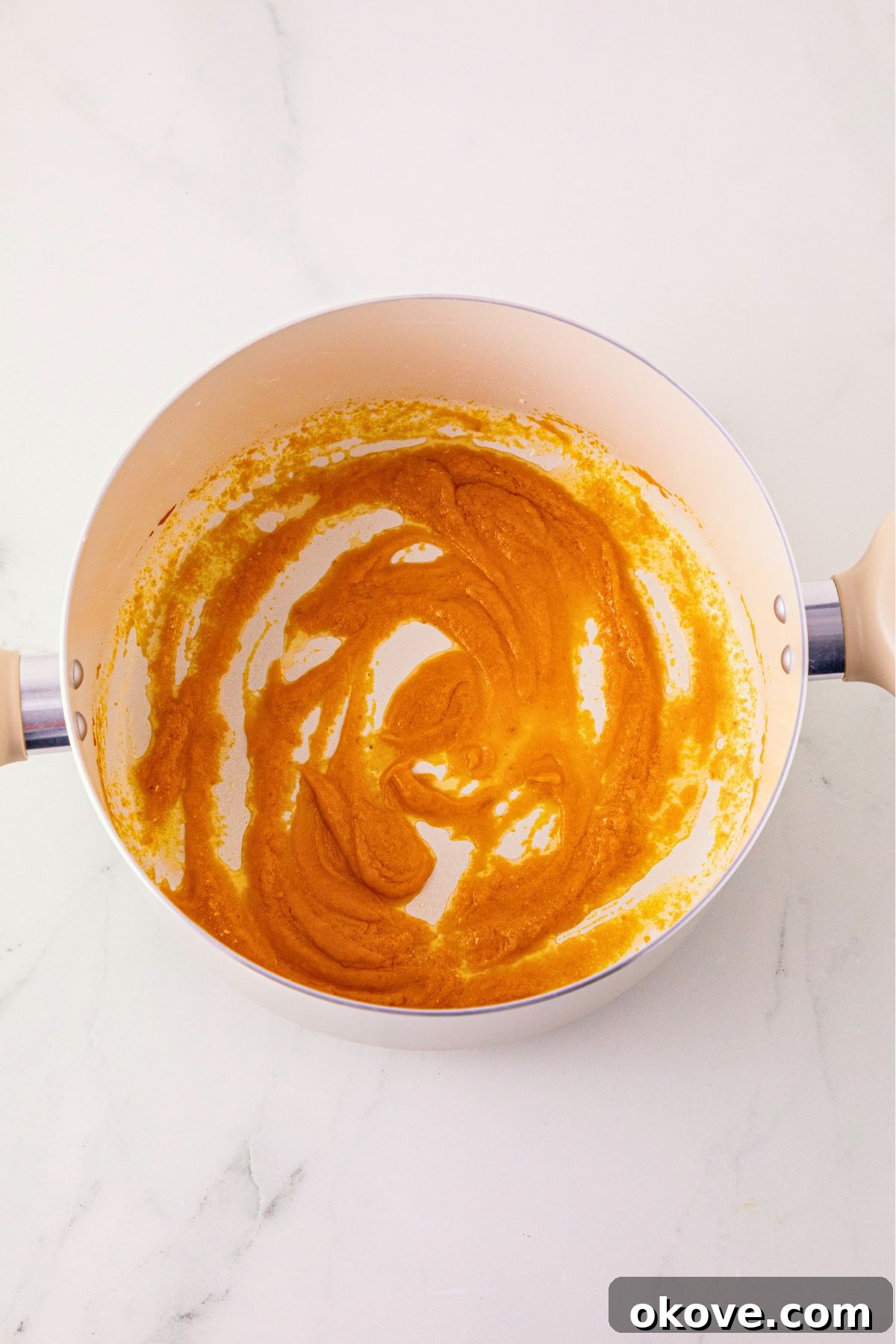 Pumpkin puree stirred into melted butter, in a large saucepan.