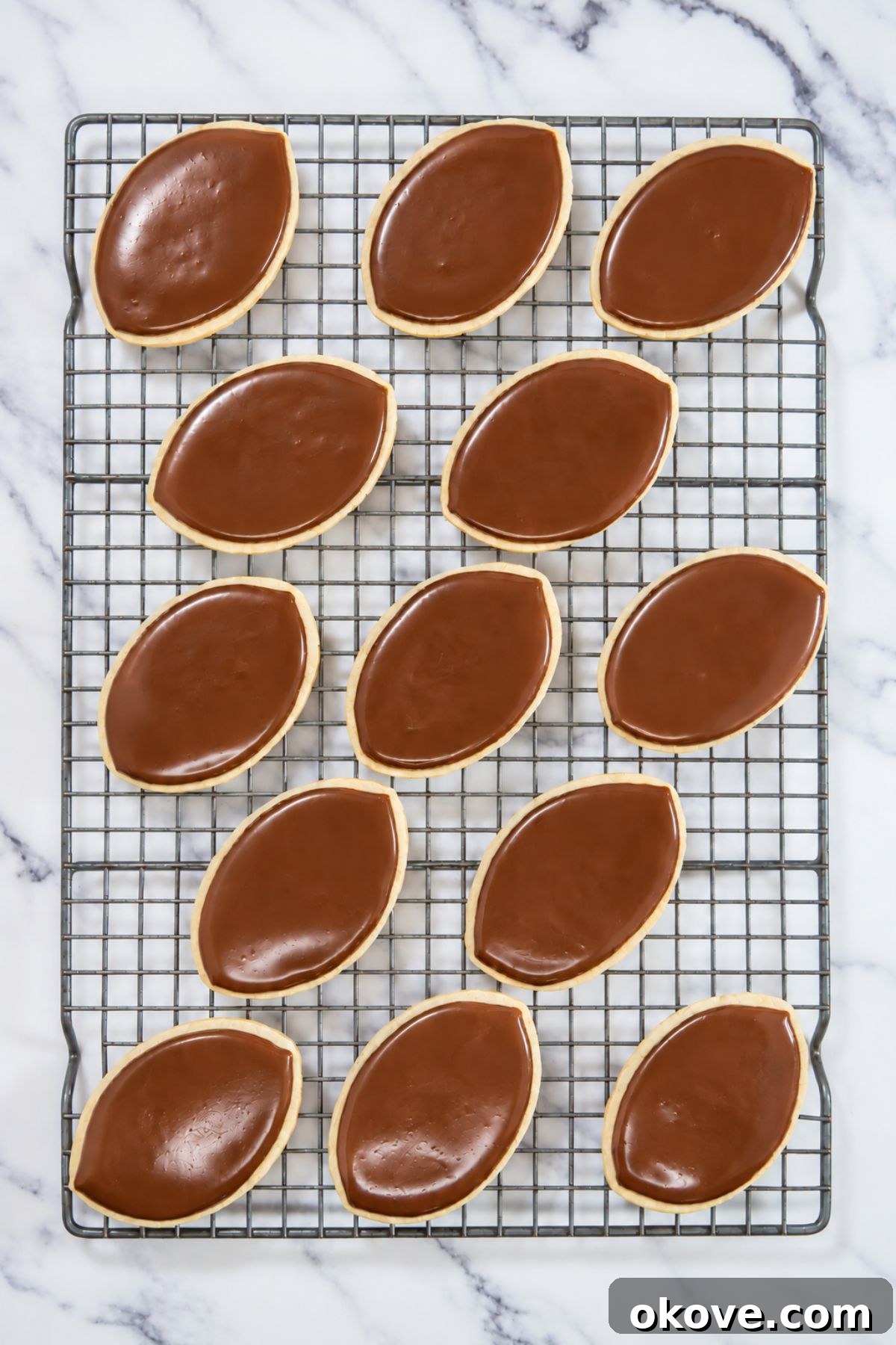 Game-Day Football Cookies: Recipes and Decorating Ideas 9 Baked football cookies frosted with brown royal icing
