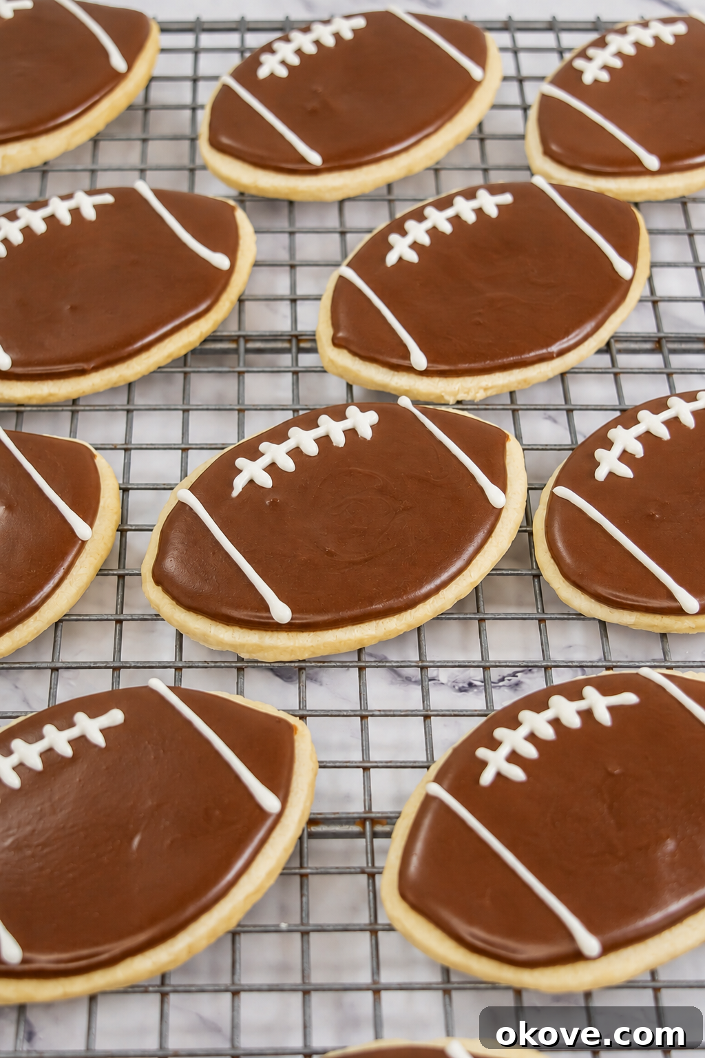 Game-Day Football Cookies: Recipes and Decorating Ideas 10 Baked football cookies decorated with brown royal icing and white laces