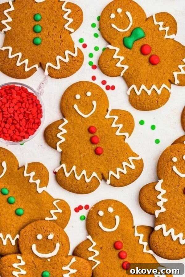 Golden brown gingerbread cookies frosted and scattered on a marble table.
