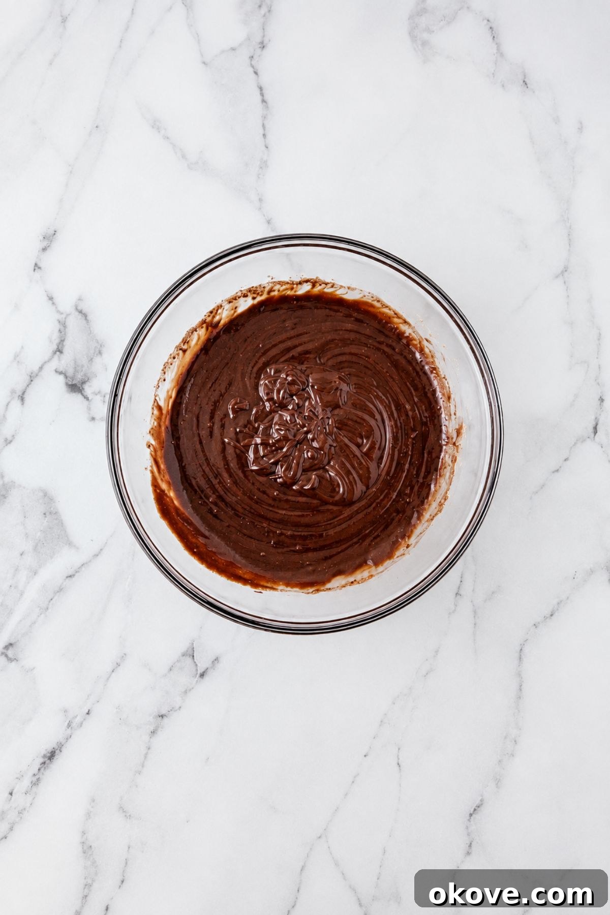 Large bowl filled with brownie mix, after combining oil, egg, and water with mix. 