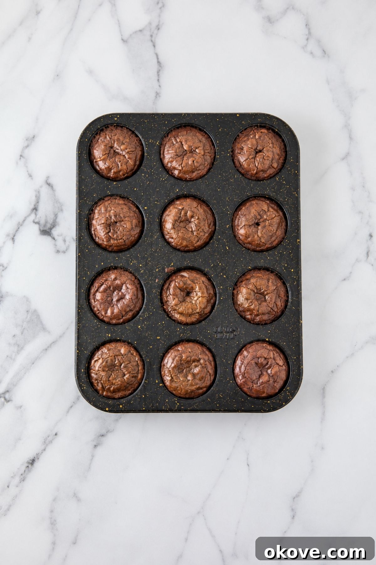 Baked brownies in a muffin pan after baking. 
